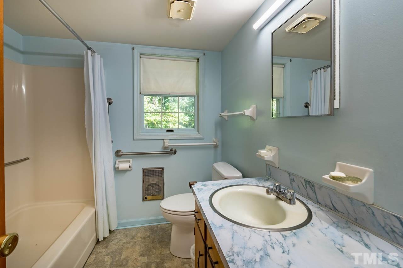 3715 Bahama Road Rougemont, NC 27572 - Photo 19 of 30 a bathroom with a granite countertop toilet a sink and a mirror