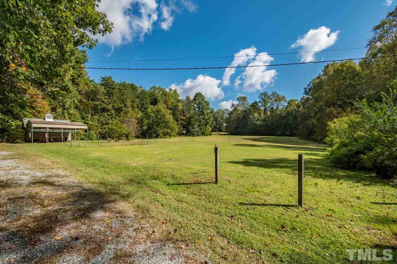 3715 Bahama Road Rougemont, NC 27572 - Photo 3 of 30 a view of a garden with a bench in the patio