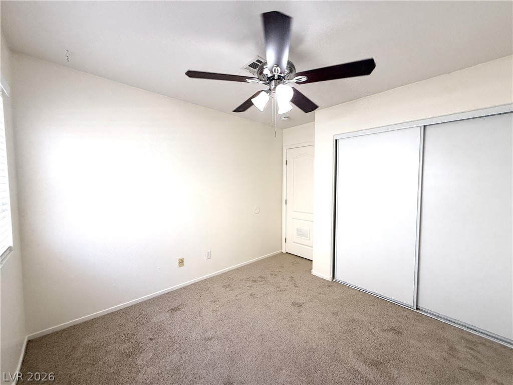 8870 Haviland Road Las Vegas, NV 89123 - Photo 15 of 22 Well-lit room featuring soft carpeting and a convenient sliding closet.