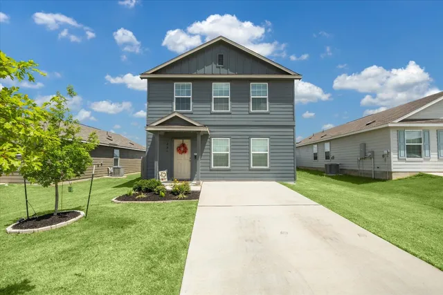 a front view of a house with a yard and garage