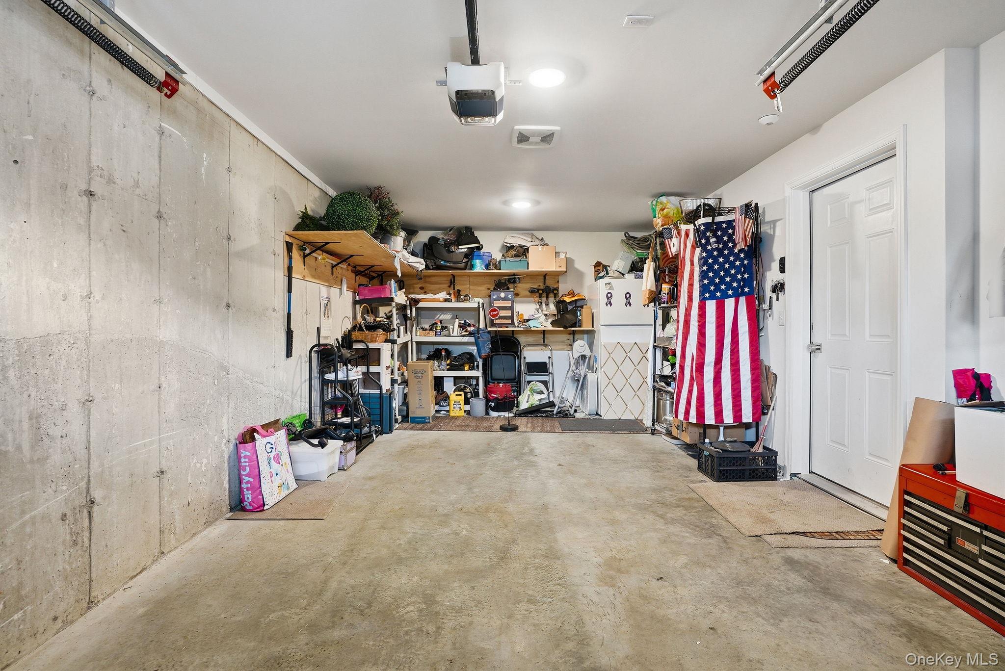 8 Muscoot River Road Granite Springs, NY 10527 - Photo 31 of 40 Spacious garage featuring a concrete floor, exposed concrete wall, overhead garage door opener, recessed lighting, and a white interior door