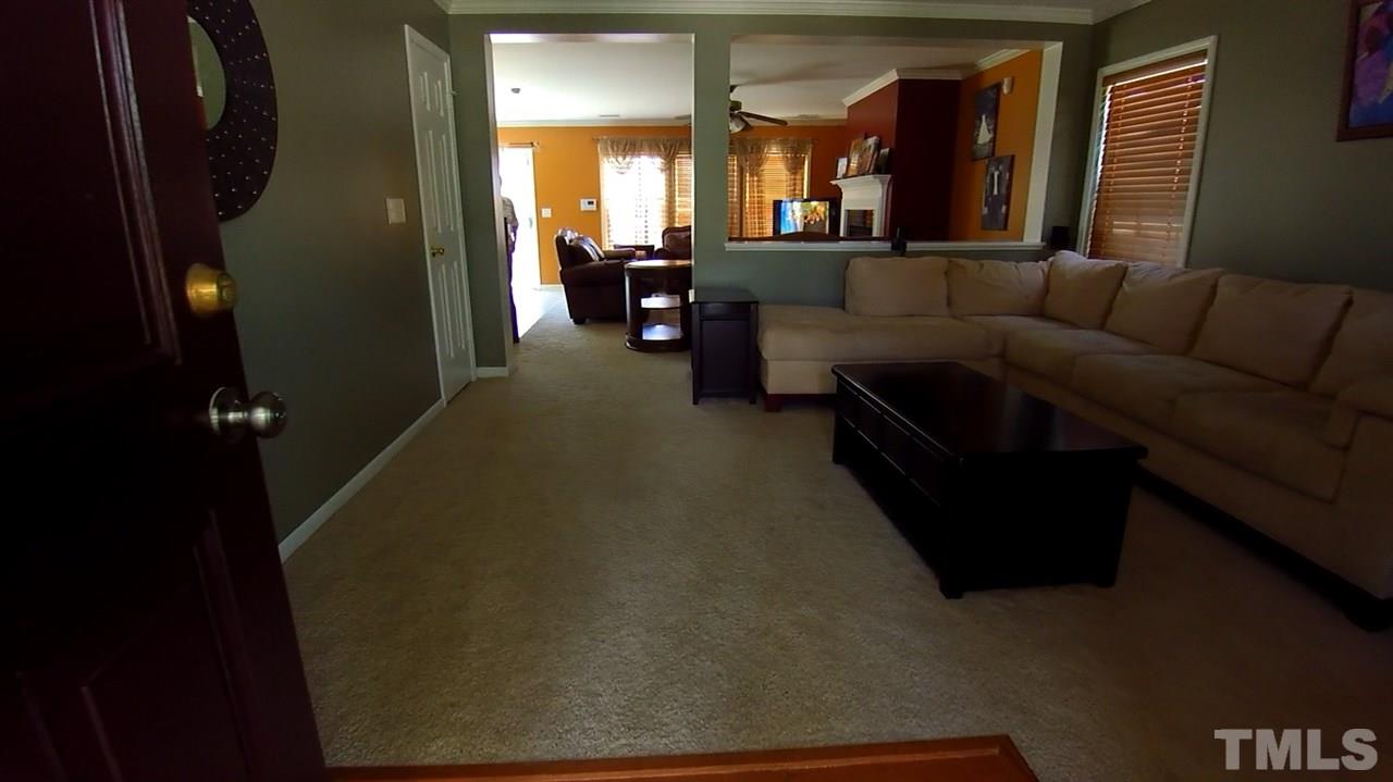 4028 Oatgrass Lane Raleigh, NC 27604 - Photo 2 of 8 a living room with furniture and a chandelier