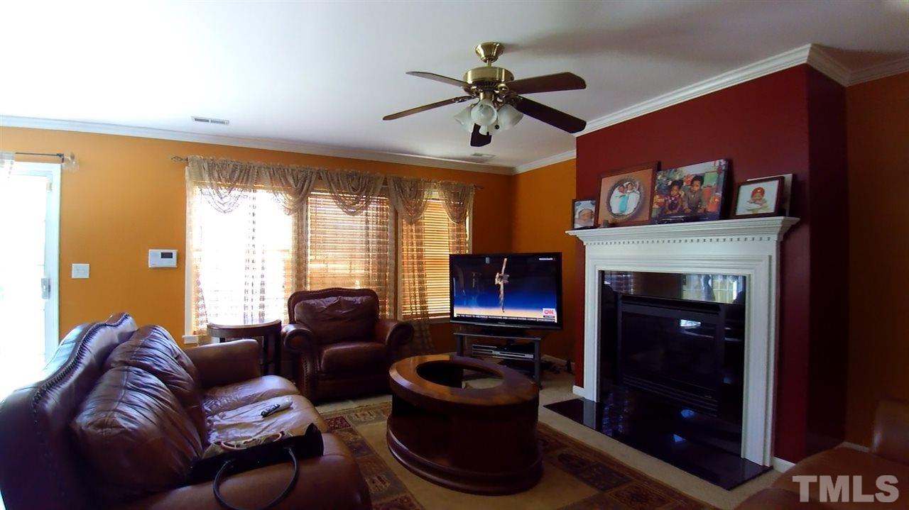 4028 Oatgrass Lane Raleigh, NC 27604 - Photo 4 of 8 a living room with furniture and a fireplace
