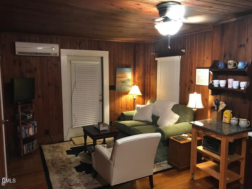 405 Sunset Avenue Clinton, NC 28328 - Photo 32 of 47 a living room with furniture and wooden floor