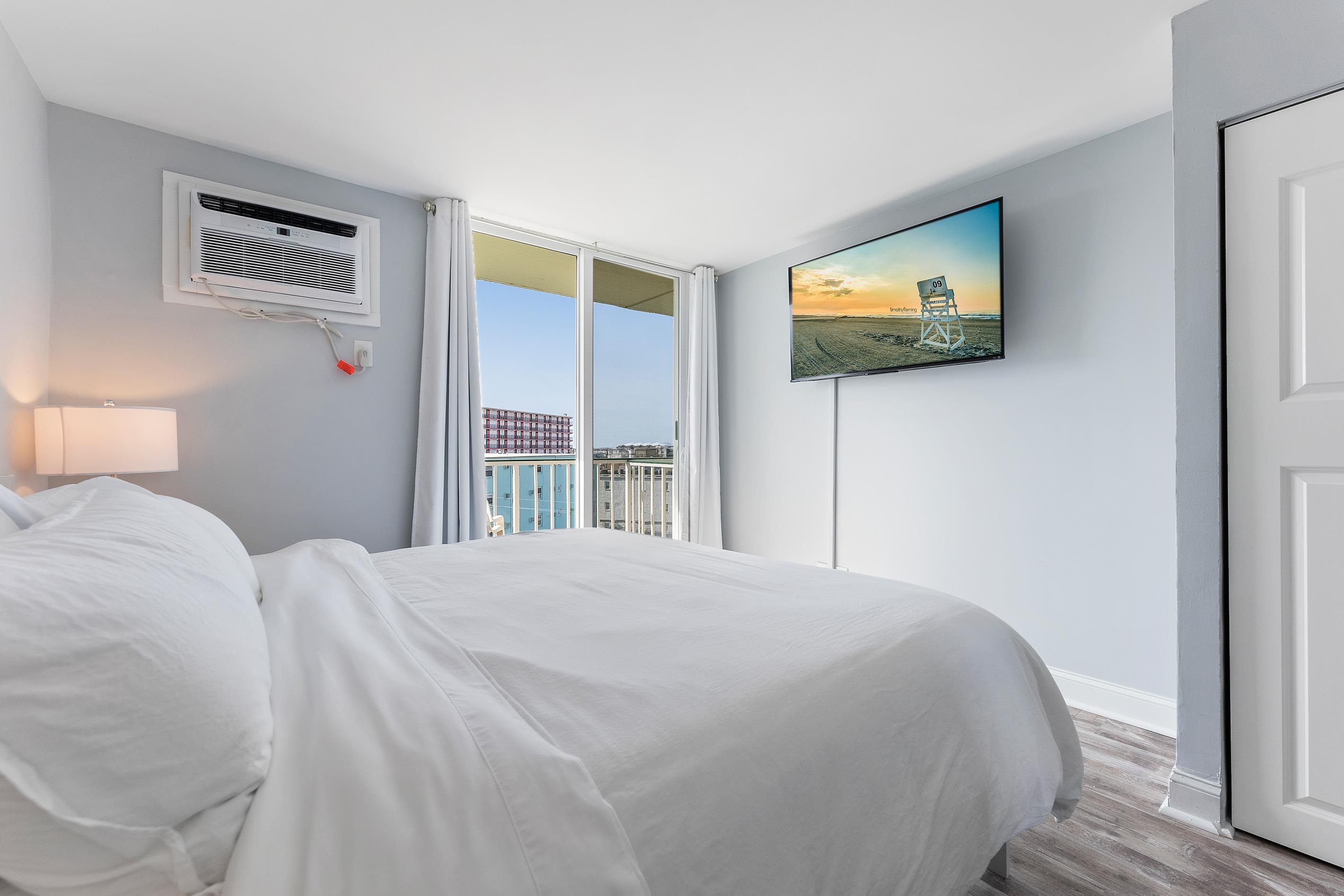225 East Wildwood Avenue, Unit 505 Wildwood, NJ 08260 - Photo 5 of 24 a bedroom with a bed and a flat screen tv