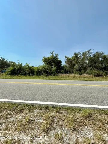 a view of a swimming pool and a yard