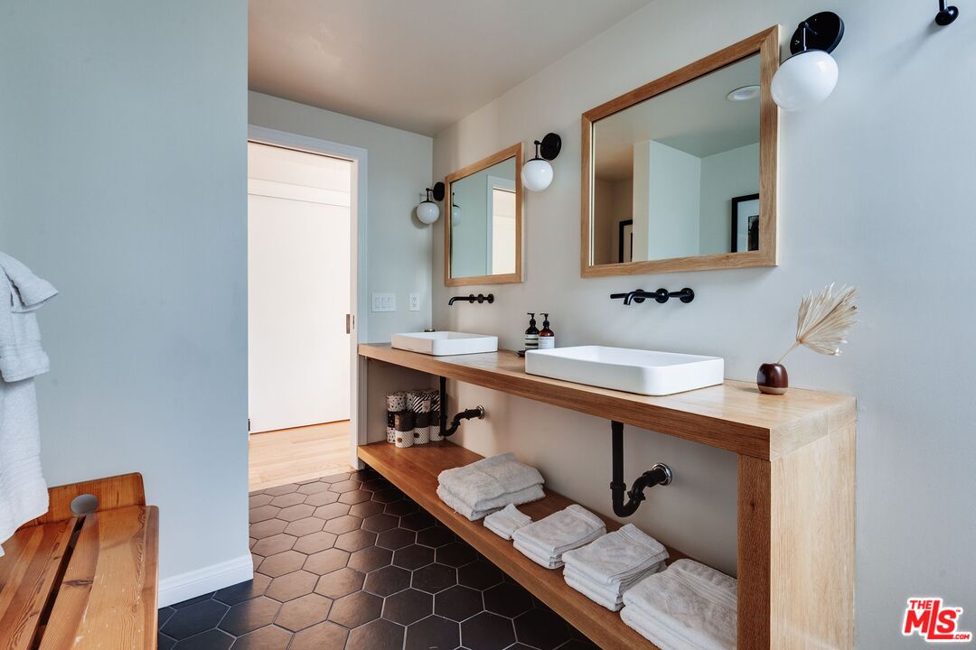 3629 Serra Road Malibu, CA 90265 - Photo 13 of 26 a bathroom with a sink mirror and a toilet