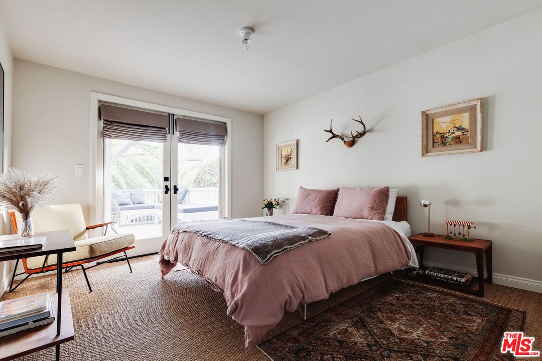 3629 Serra Road Malibu, CA 90265 - Photo 14 of 26 a bedroom with a bed and a table