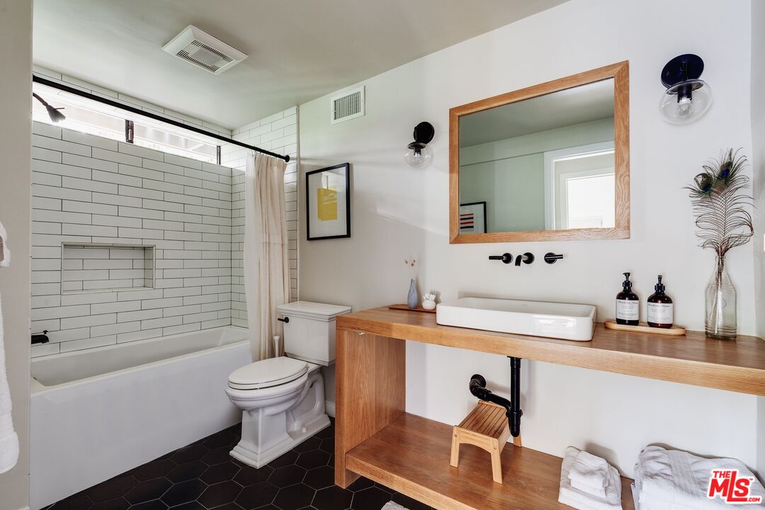 3629 Serra Road Malibu, CA 90265 - Photo 15 of 26 a bathroom with a sink a toilet and shower