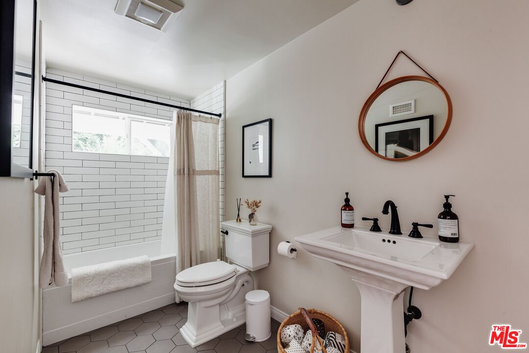 3629 Serra Road Malibu, CA 90265 - Photo 18 of 26 a bathroom with a sink a toilet and a mirror