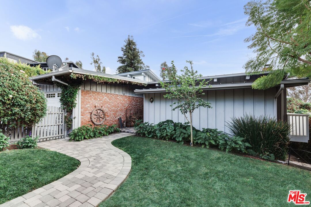 3629 Serra Road Malibu, CA 90265 - Photo 2 of 26 a front view of a house with garden