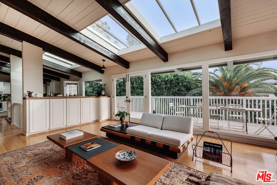 3629 Serra Road Malibu, CA 90265 - Photo 6 of 26 a living room with furniture and a floor to ceiling window