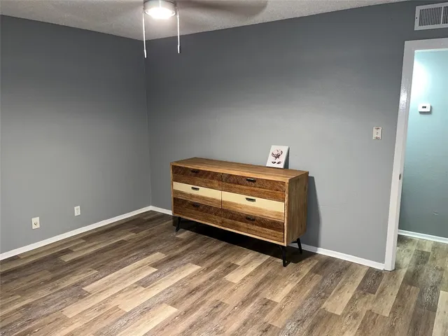 a view of room with wooden floor