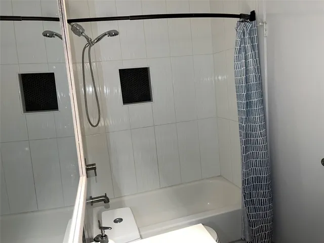 a bathroom with a shower and a glass door shower