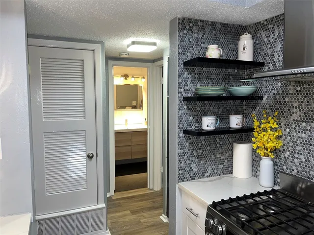 a kitchen with a stove and cabinets