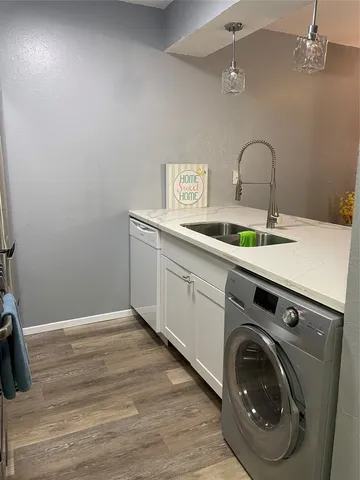 a utility room with sink dryer and washer