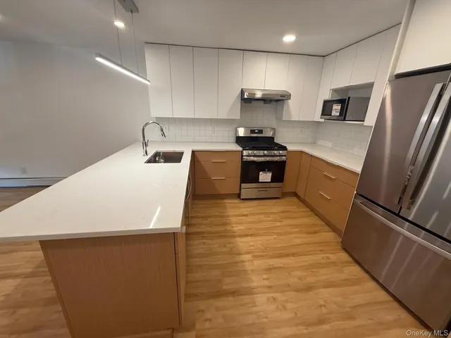 a kitchen with stainless steel appliances a refrigerator sink and stove
