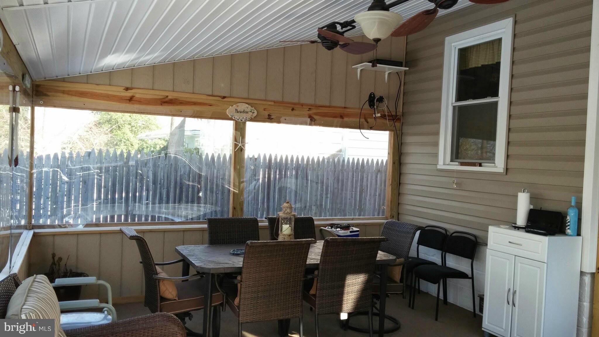 196 Pike Road Pasadena, MD 21122 - Photo 24 of 30 Large screened in porch with table