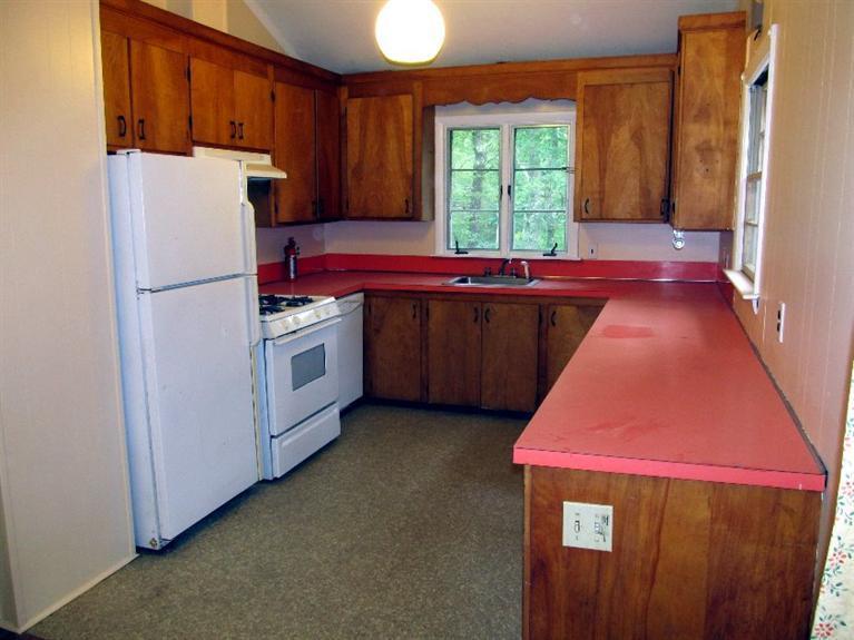 52 F R Lillie Road Woods Hole, MA 02543 - Photo 6 of 17 a kitchen with stainless steel appliances granite countertop a refrigerator a sink a stove and a refrigerator