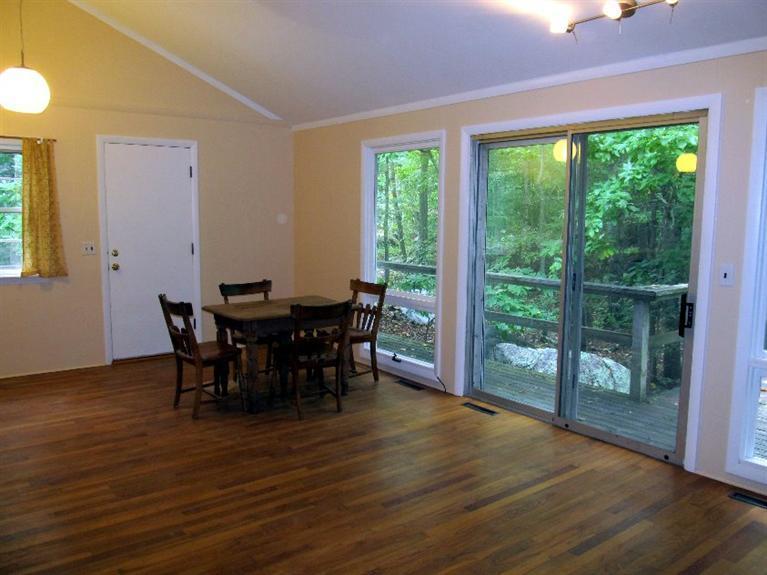 52 F R Lillie Road Woods Hole, MA 02543 - Photo 7 of 17 a view of a dining room with furniture and wooden floor