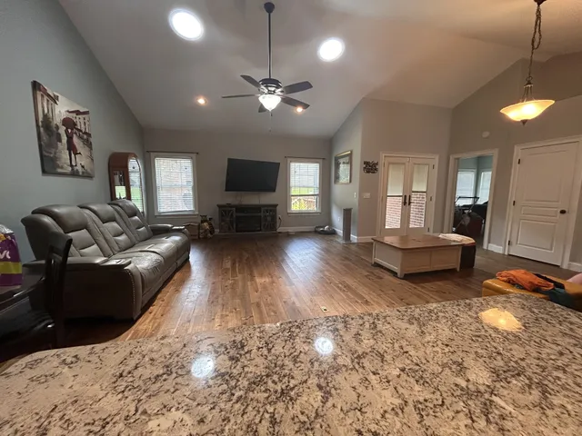 a living room with furniture and a flat screen tv