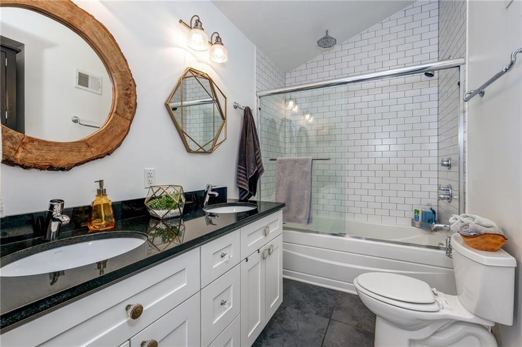 3622 Smallman Street Pittsburgh, PA 15201 - Photo 22 of 25 The mater bath has serious design appeal! Custom features include: Double sink vanity with undermount Decolav sinks, Hans Grohe sink faucets, dramatic subway tiled shower with Kohler soaking tub, unique mirrors, and a custom storage cabinet.