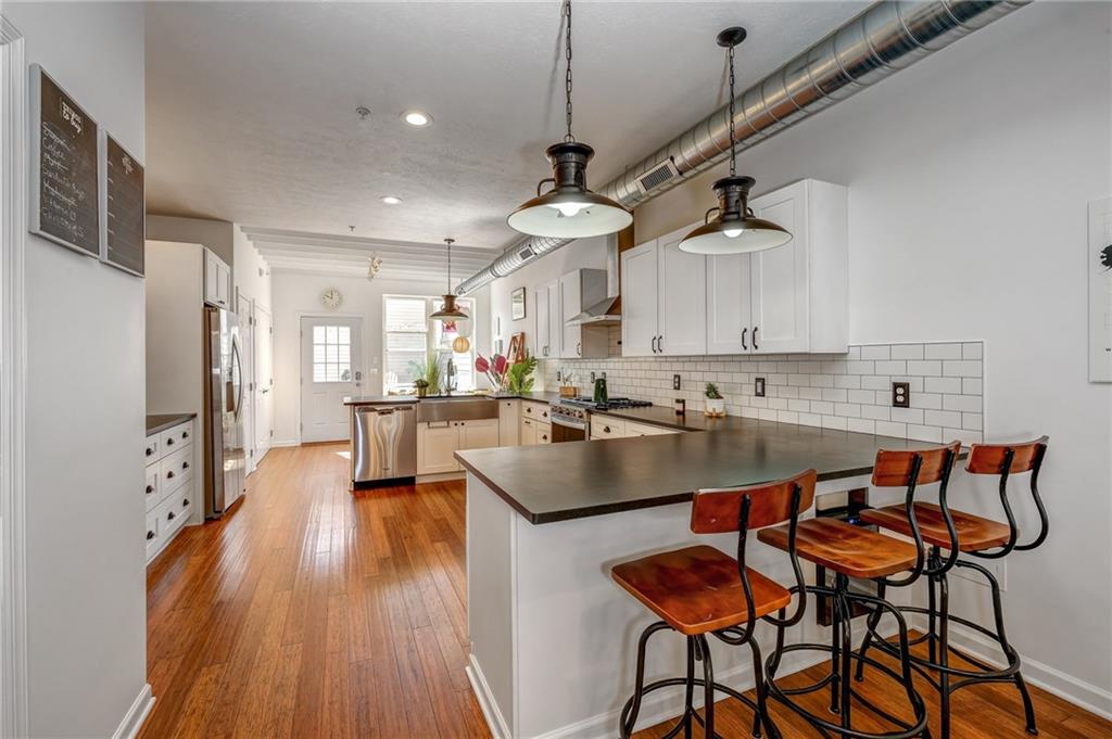 3622 Smallman Street Pittsburgh, PA 15201 - Photo 7 of 25 The amazing kitchen features leathered countertops, subway tile, and shiplap accents! The room opens to the dining and living room and there is a kitchen nook at the rear of the space that opens to the back paver patio yard!