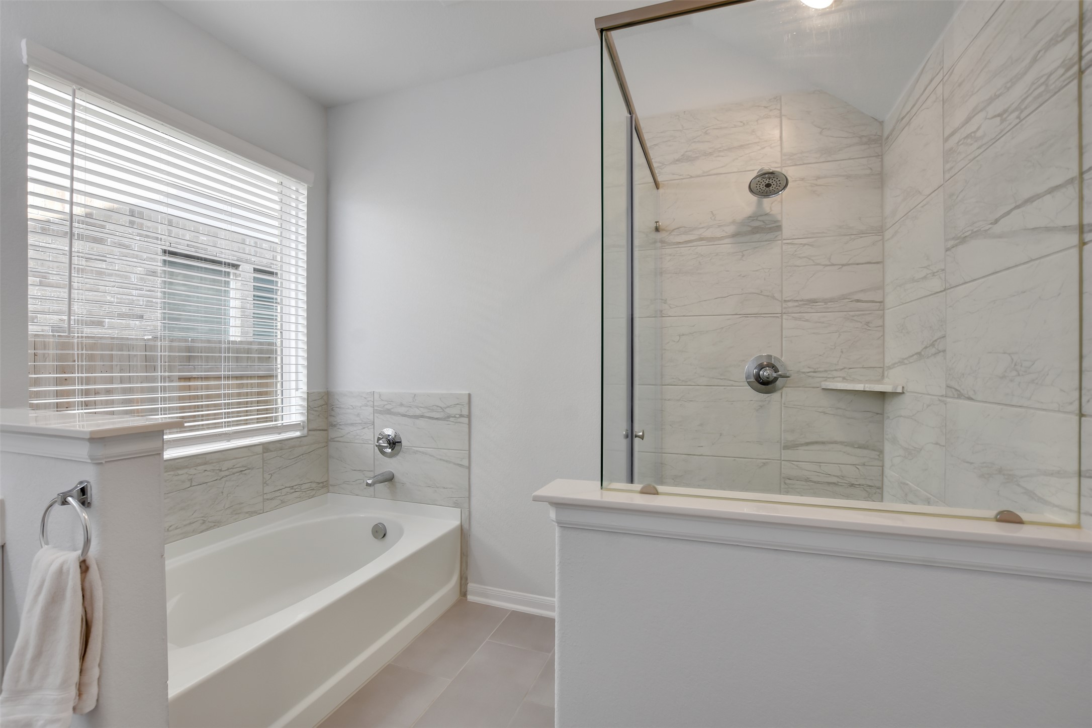 605 Oleander Loop Buda, TX 78610 - Photo 17 of 32 a bathroom with a bathtub and a shower