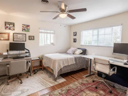 a living room with furniture a rug and a window