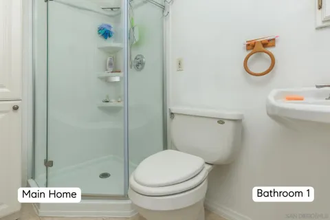 a view of a kitchen with a sink and dishwasher with wooden floor