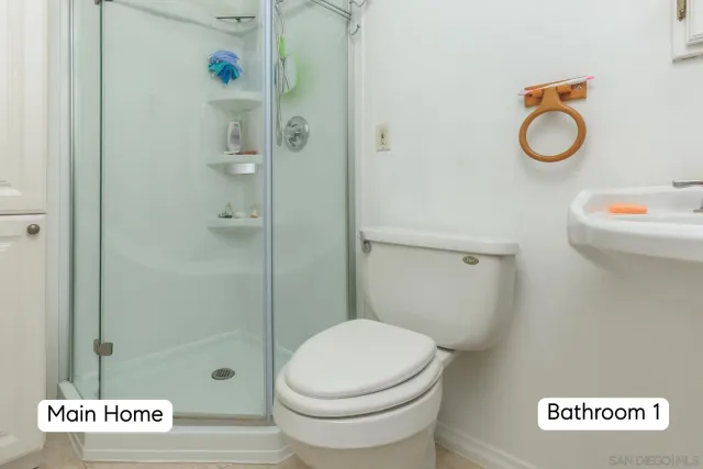 a view of a kitchen with a sink and dishwasher with wooden floor