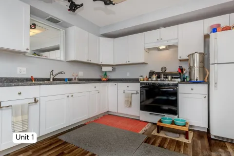 a living room with furniture a window and a flat screen tv