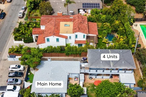 an aerial view of a house with pool and garden