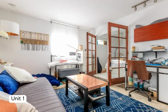 a bedroom with a bed and a night stand