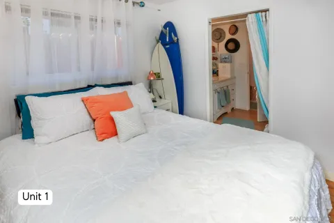 an aerial view of residential houses with outdoor space and parking