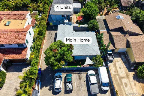 a aerial view of a house with a yard and potted plants