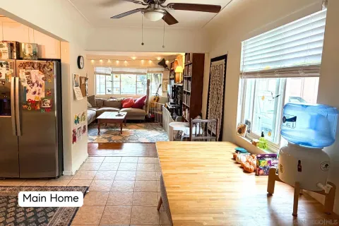 a living room with furniture and a kitchen view