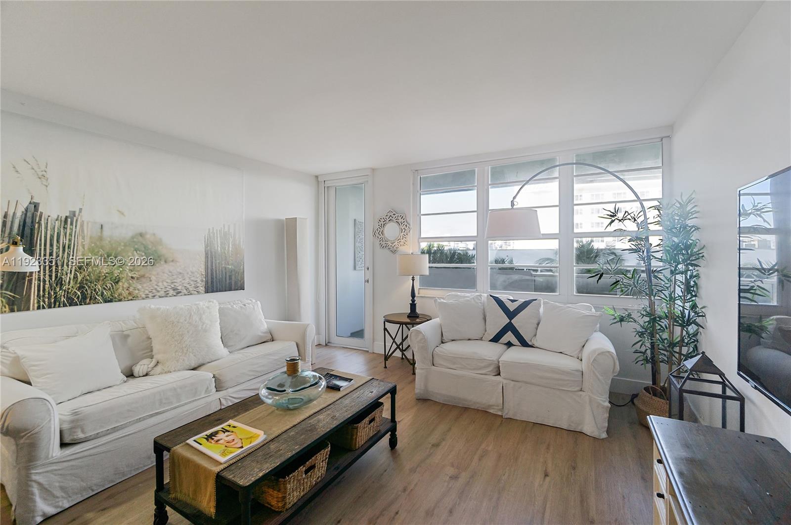 a living room with furniture and a large window