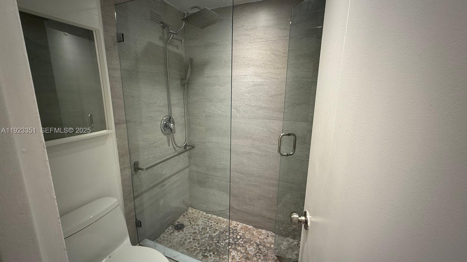 100 Lincoln Road, Unit 410 Miami Beach, FL 33139 - Photo 12 of 18 a bathroom with a shower and toilet