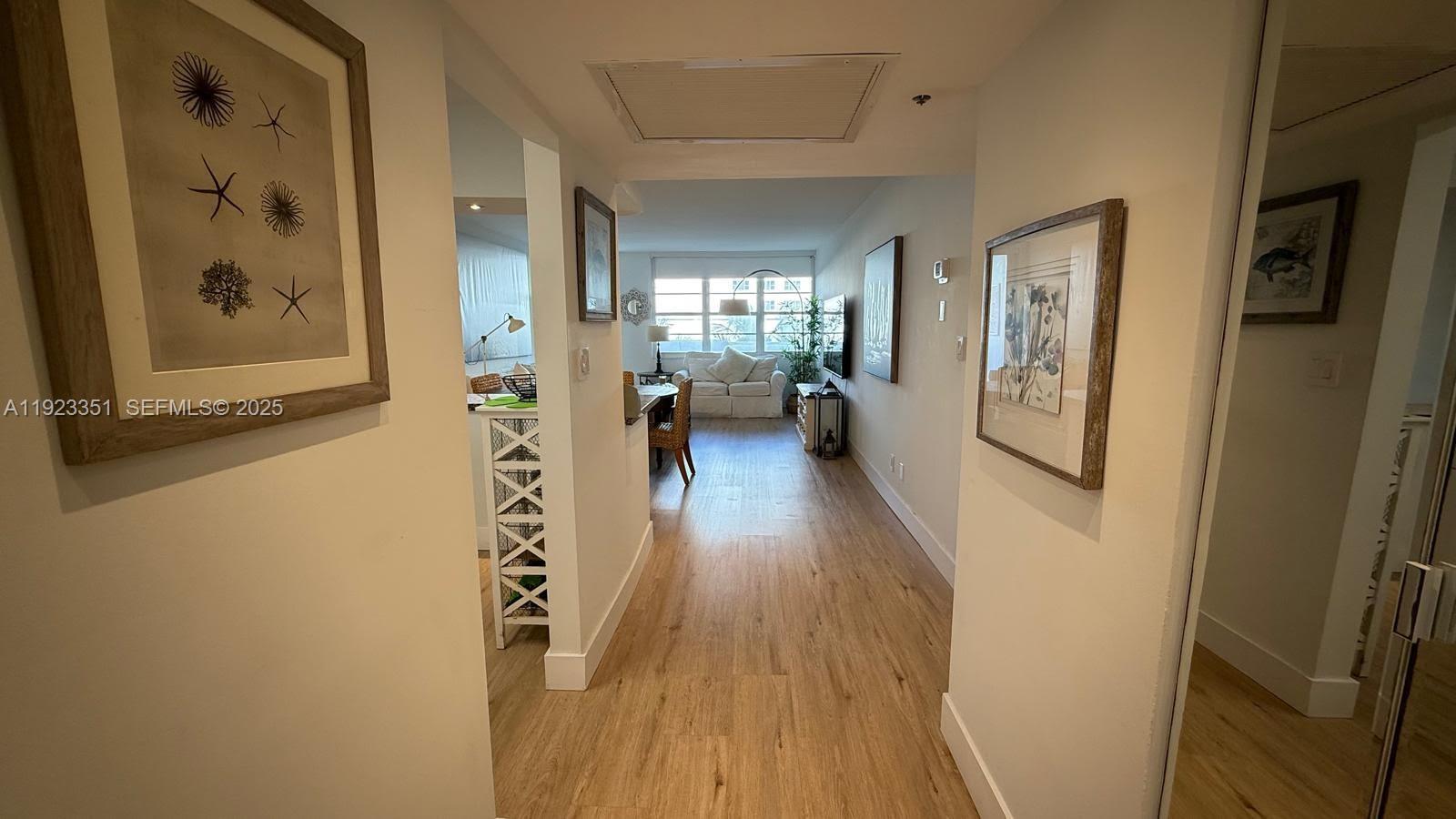 100 Lincoln Road, Unit 410 Miami Beach, FL 33139 - Photo 13 of 18 a view of a hallway with wooden floor and furniture