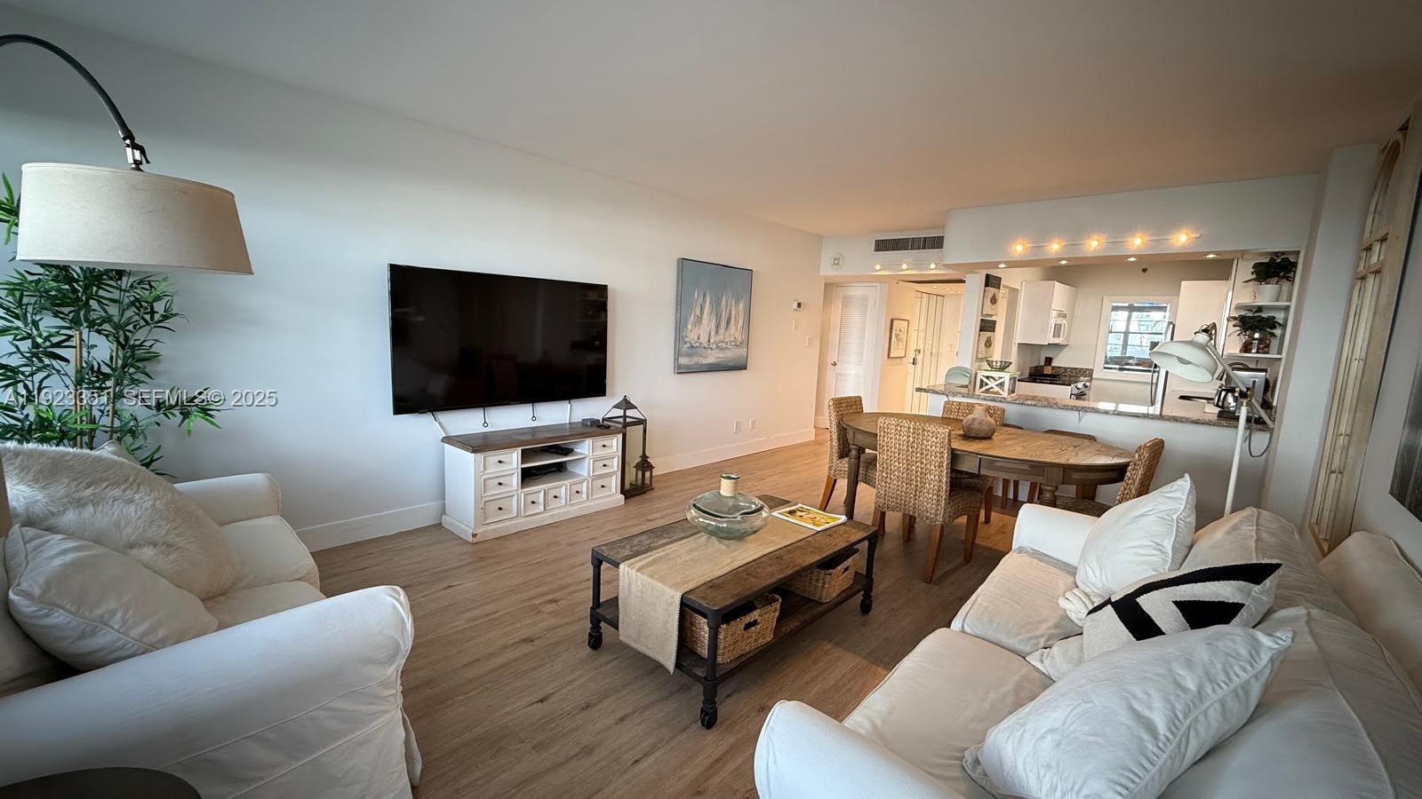 100 Lincoln Road, Unit 410 Miami Beach, FL 33139 - Photo 2 of 18 a living room with furniture and a flat screen tv