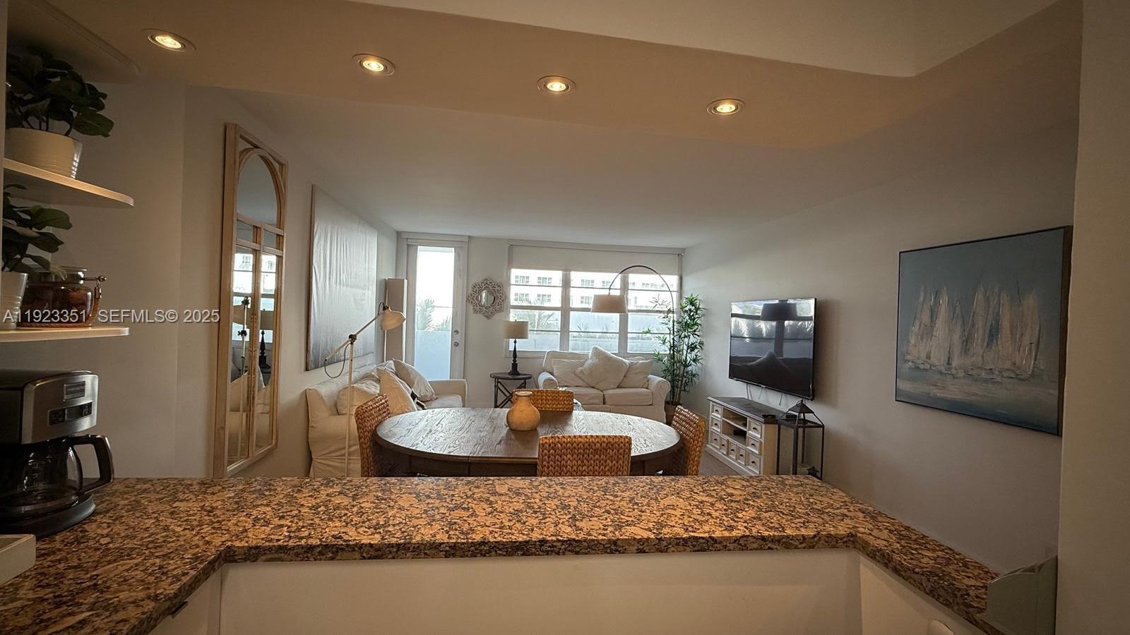 100 Lincoln Road, Unit 410 Miami Beach, FL 33139 - Photo 3 of 18 a living room with furniture and a wooden floor