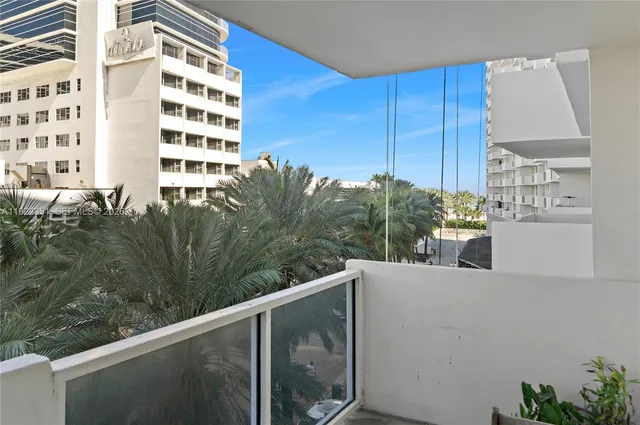 a view of a balcony with wooden floor and fence