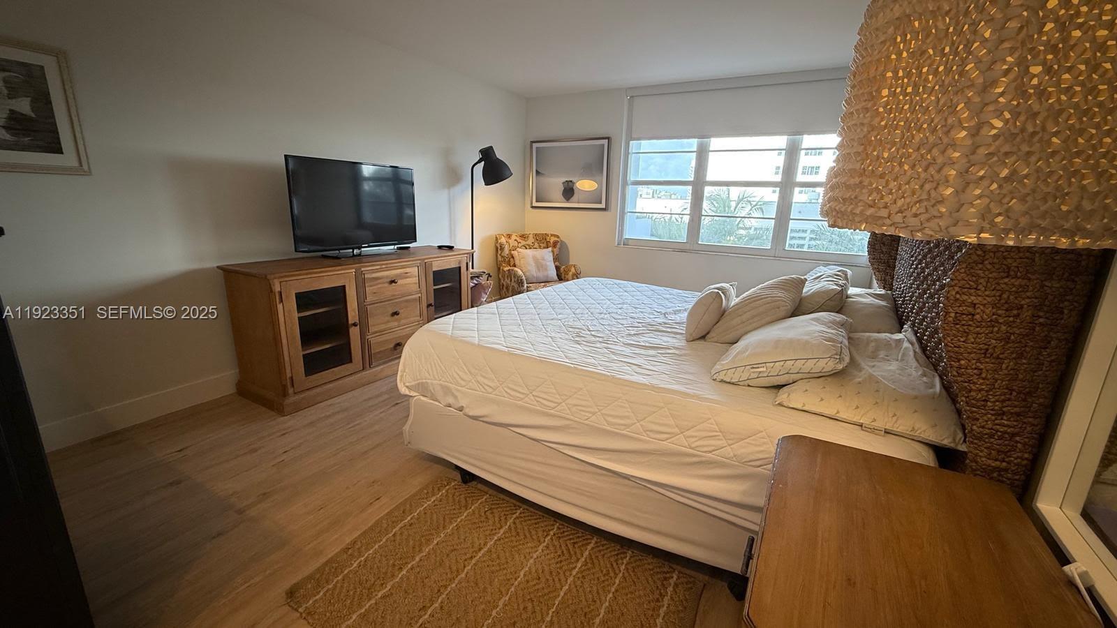 100 Lincoln Road, Unit 410 Miami Beach, FL 33139 - Photo 8 of 18 a bedroom with a bed and a television in it