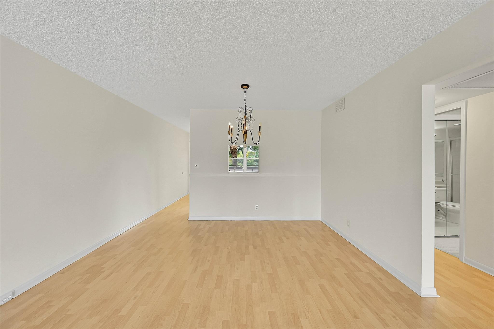 1804 Eleuthera Point, Unit E3 Coconut Creek, FL 33066 - Photo 12 of 41 a view of a room with wooden floor and windows
