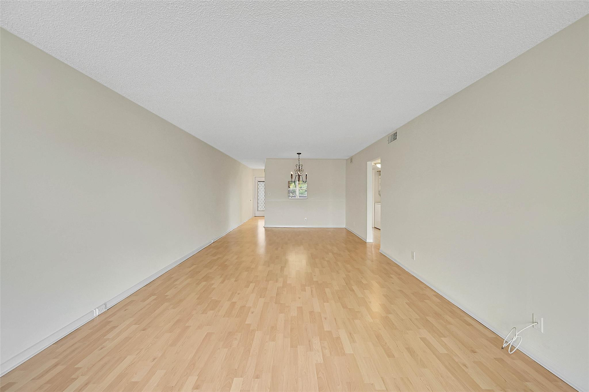 1804 Eleuthera Point, Unit E3 Coconut Creek, FL 33066 - Photo 14 of 41 a view of empty room with wooden floor