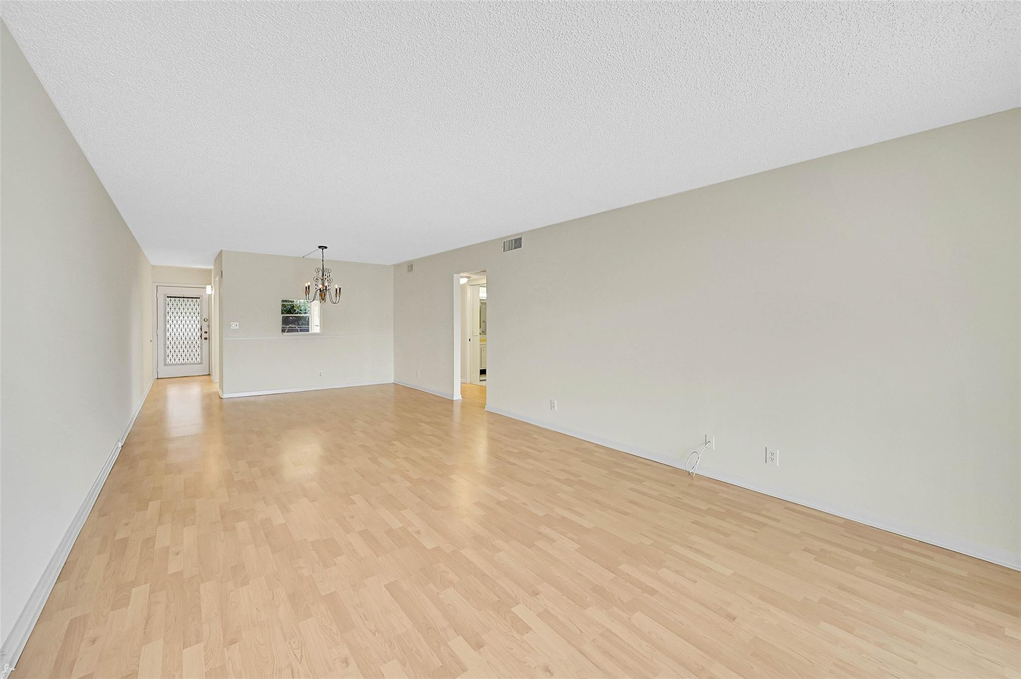 1804 Eleuthera Point, Unit E3 Coconut Creek, FL 33066 - Photo 15 of 41 a view of empty room with wooden floor