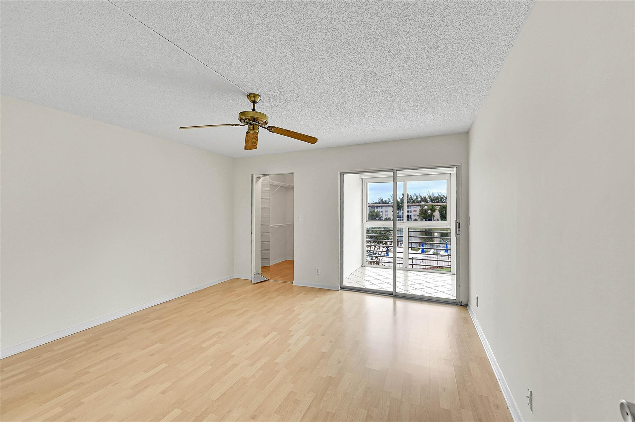 1804 Eleuthera Point, Unit E3 Coconut Creek, FL 33066 - Photo 16 of 41 wooden floor in an empty room with a window