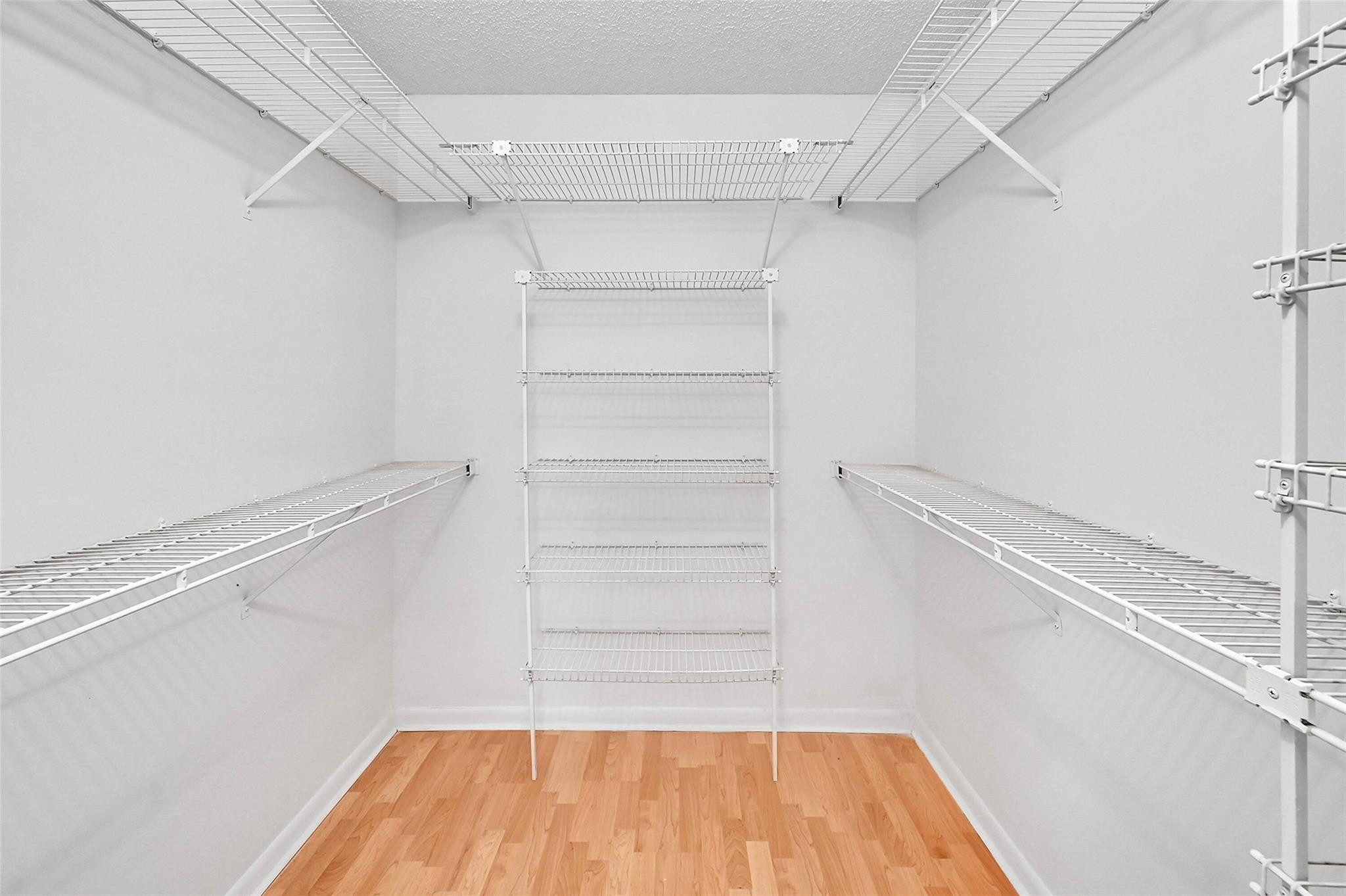 1804 Eleuthera Point, Unit E3 Coconut Creek, FL 33066 - Photo 18 of 41 a view of walk in closet with empty racks