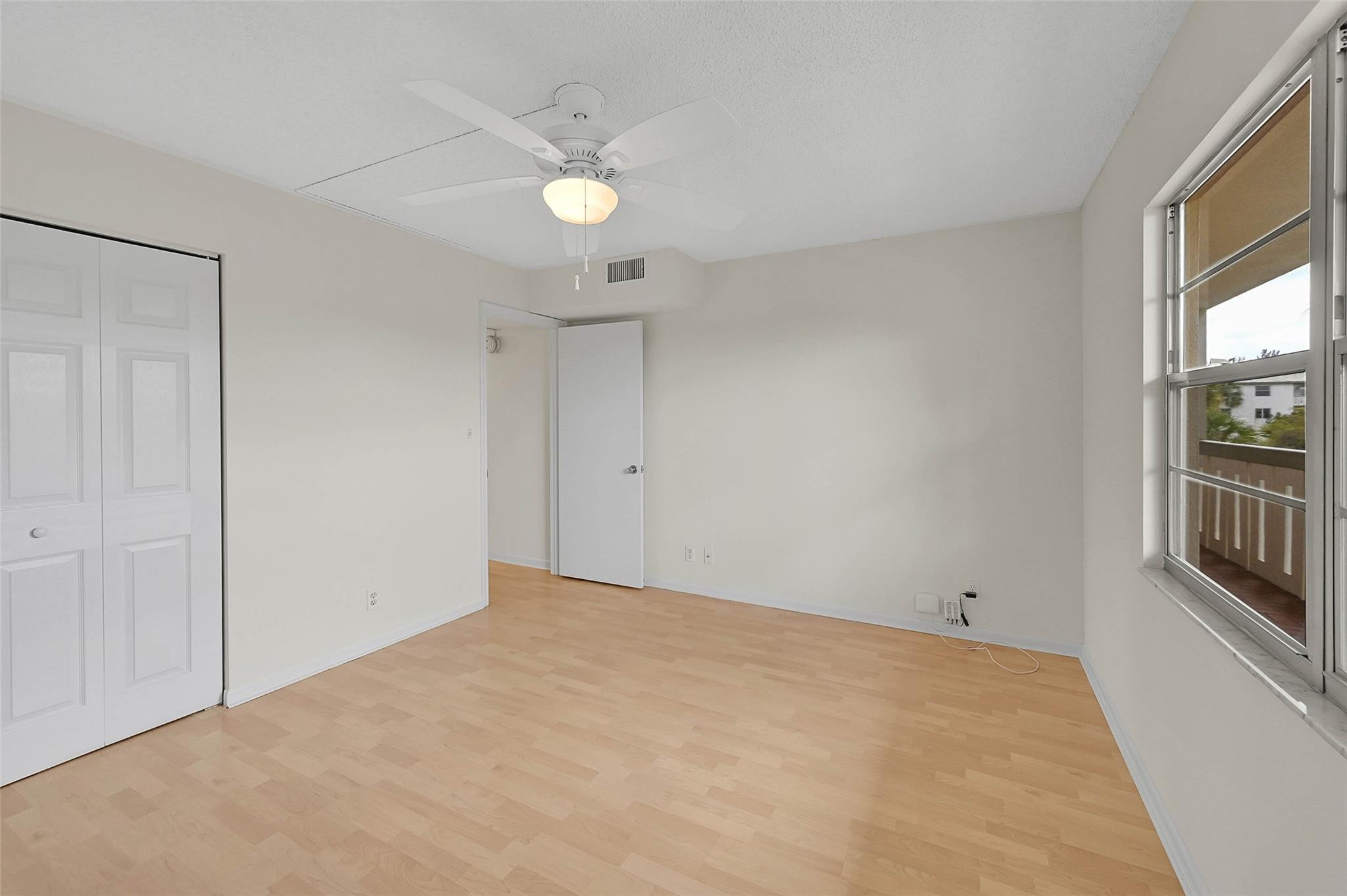 1804 Eleuthera Point, Unit E3 Coconut Creek, FL 33066 - Photo 24 of 41 a view of an empty room with a window